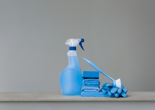 Photo cleaning blue spray bottle with plastic dispenser, sponge, scrubbing brush