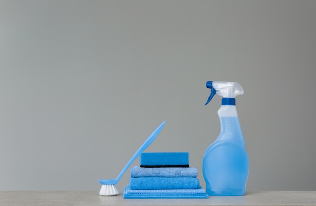 Cleaning blue spray bottle with plastic dispenser, sponge