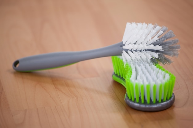 Cleaning brush on wooden floor