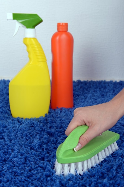 Cleaning carpet with brush close up