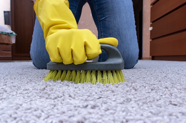 Cleaning carpet with a brush