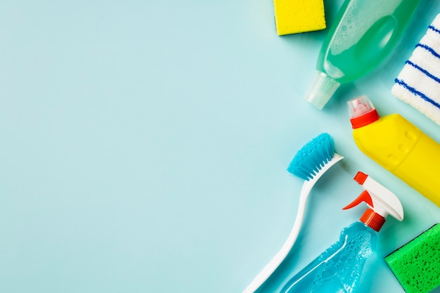 Cleaning concept. Set of cleaning supplies on blue background with copy space, top view