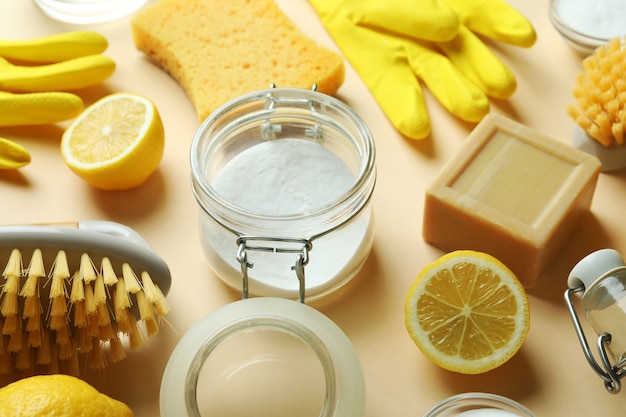Cleaning concept with eco friendly cleaning tools and lemons on beige isolated background