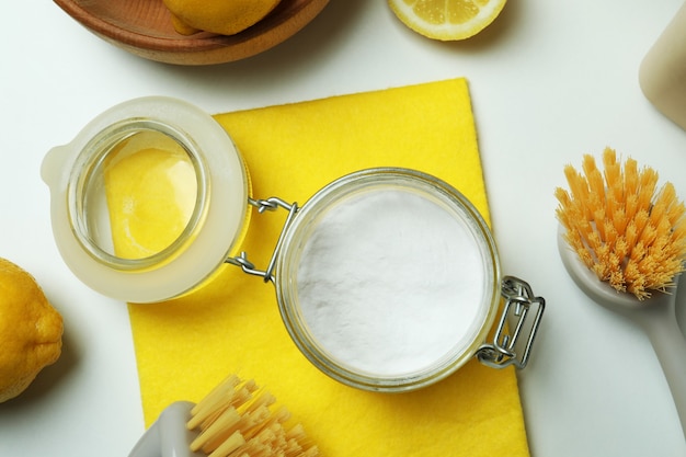 Cleaning concept with eco friendly cleaning tools and lemons on white isolated background