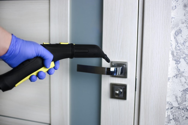 Cleaning and disinfection of the door handle with hot steam Professional cleaning
