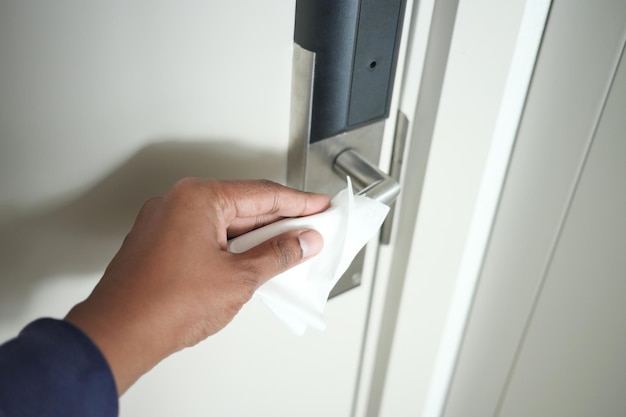 Cleaning door knob with tissue close up