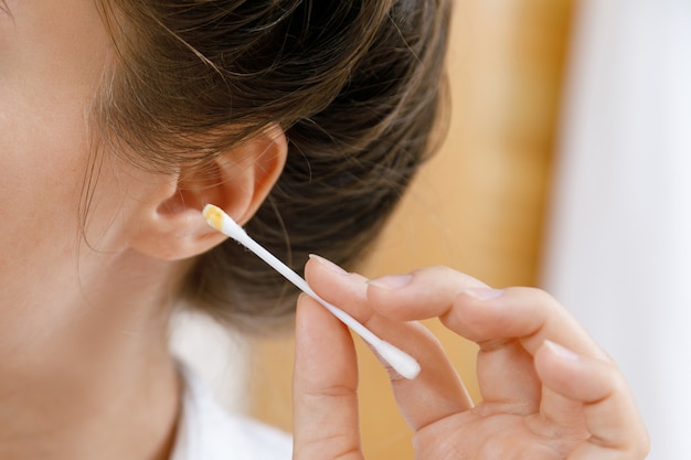 Photo cleaning ear with a cotton swab