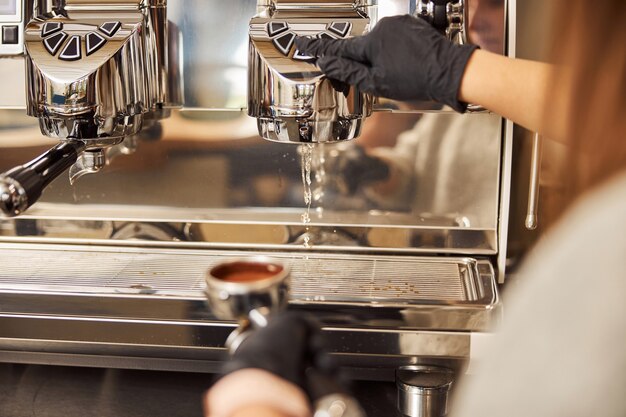 Cleaning the espresso machine before making new cup of coffee