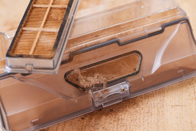 Cleaning the filter of the vacuum robot cleaner from dirt closeup