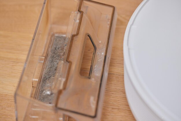 Cleaning the filter of the vacuum robot cleaner from dirt closeup