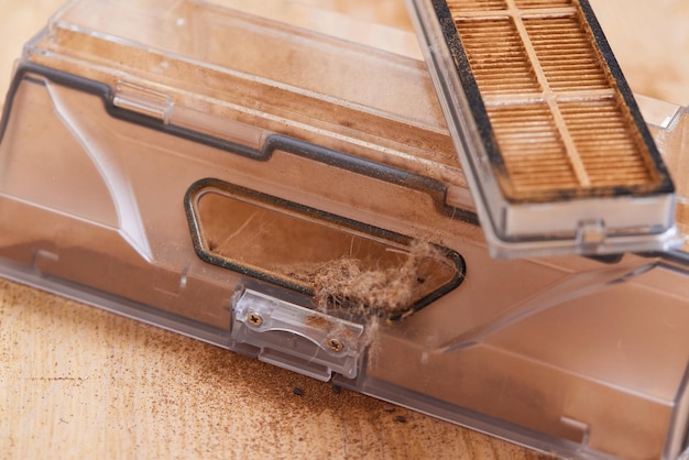 Cleaning the filter of the vacuum robot cleaner from dirt closeup