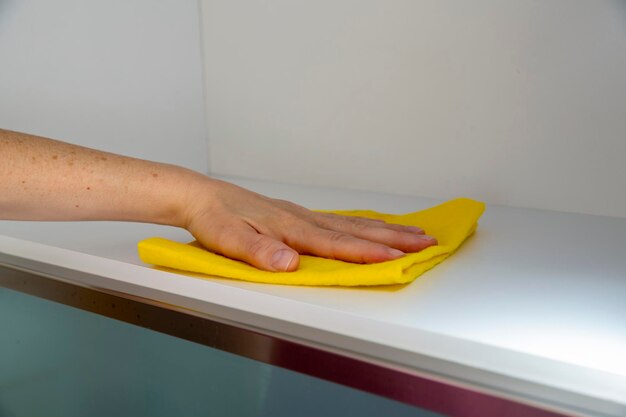 Photo cleaning furniture with yellow cloth