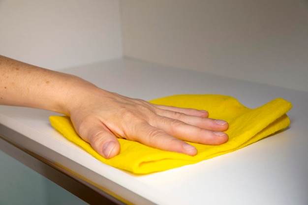 Cleaning furniture with yellow cloth