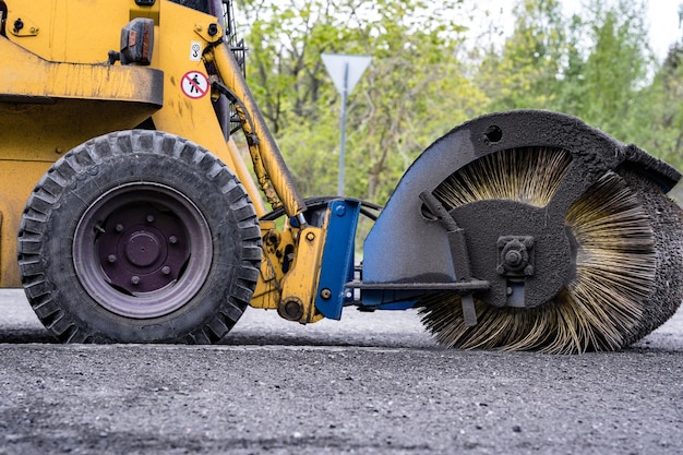 Cleaning of garbage from the road a rotating mechanical machine brush