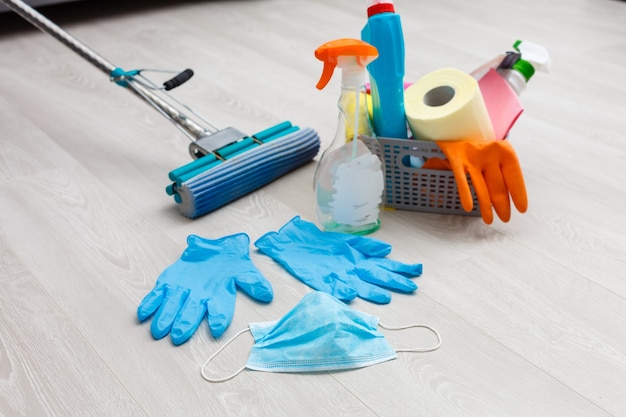 cleaning, health and hygiene concept - rprotection from virus disease in gloves with detergent and mop at home