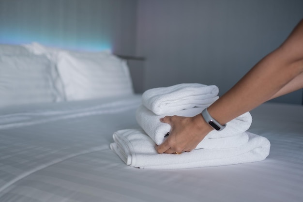 cleaning hotel bath towel on white bed room service