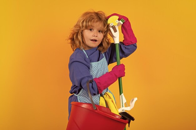 Cleaning house studio isolated portrait of child mopping house cleaning home detergents and cleaning accessories cleaning service little boy funny housekeeper