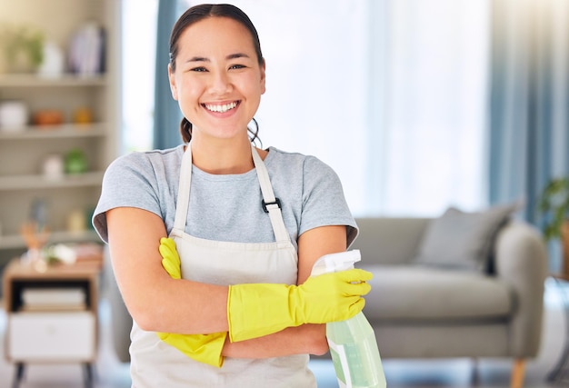Cleaning housekeeping and portrait of Asian woman with detergents for spring cleaning dust dirt and disinfection Housework cleaning service and happy female with spray bottle of cleaning products