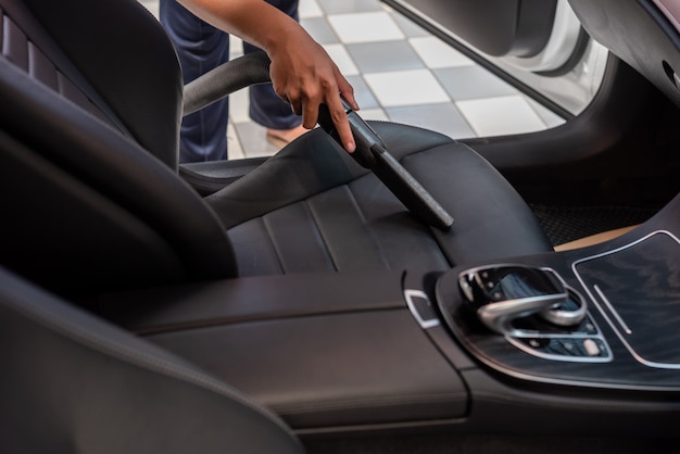 Cleaning of interior of the car with vacuum cleaner