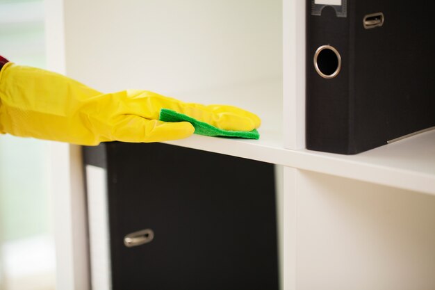 cleaning lady does the cleaning in the office with a wet cloth.