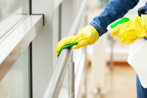 cleaning lady does the cleaning in the office with a wet cloth.