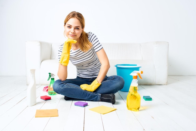 Cleaning lady sitting on the floor cleaning supplies cleaning house interior