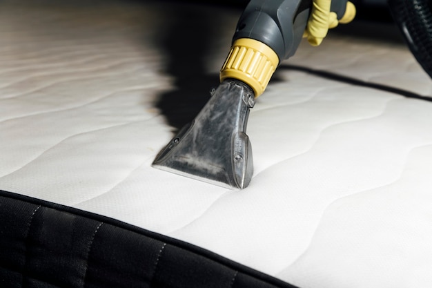 cleaning the mattress with a washing vacuum cleaner