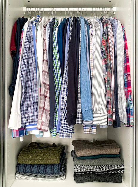 Cleaning and organising of mans wardrobevariety of colorful casual and business shirts