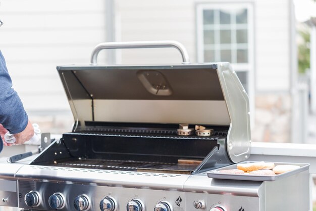 Cleaning outdoor gas grill before next grilling.