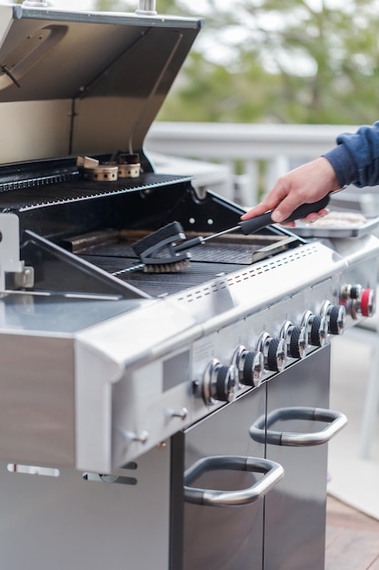 Cleaning outdoor gas grill before next grilling.