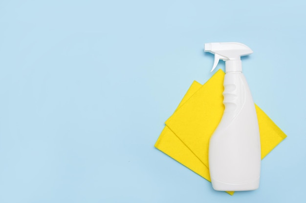 cleaning products on blue background with copy space