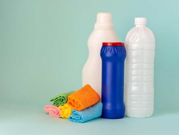 Cleaning products bottles of liquid products and cans of powder rags in a beautiful plastic box with