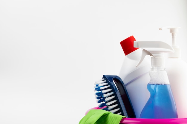 Photo cleaning products and gloves in pink basin