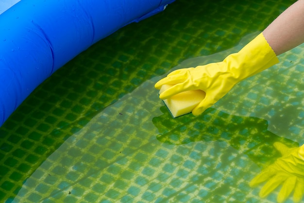 Cleaning pvc inflatable swimming pool, cleaning the dirty empty pool of algae