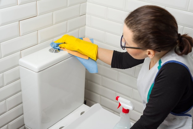 Cleaning service. woman wash the toilet