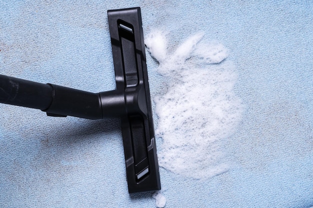 Cleaning the sofa with a brush of a vacuum cleaner and detergent chemistry