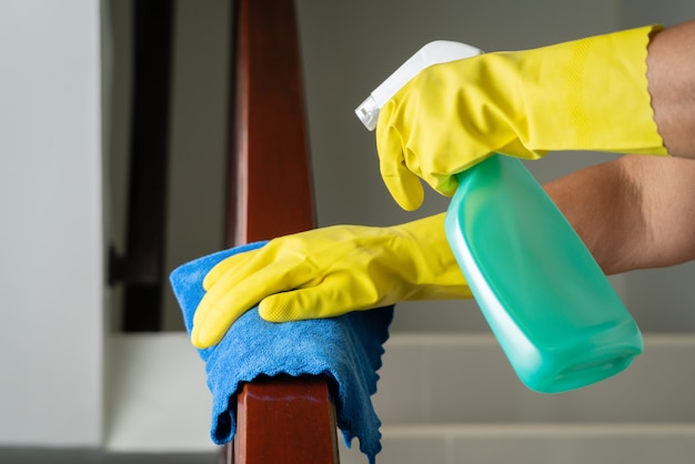 Cleaning stair handrail with alcohol spray