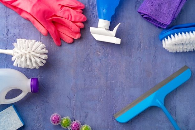 Cleaning supplies for household flatlay on gray background