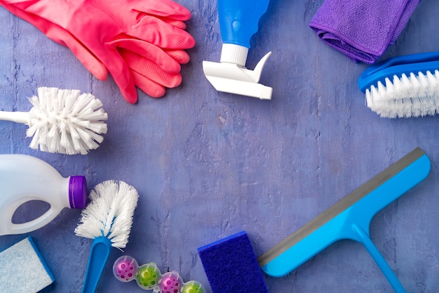 Cleaning supplies for household flatlay on gray background