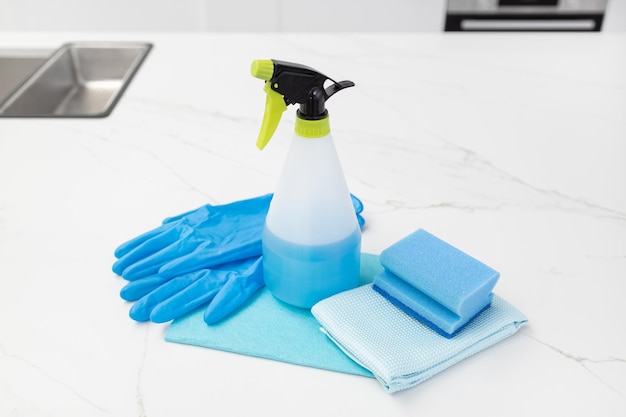 Cleaning supplies on modern kitchen house cleaning concept copy space