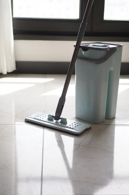 cleaning tiles floor with mop