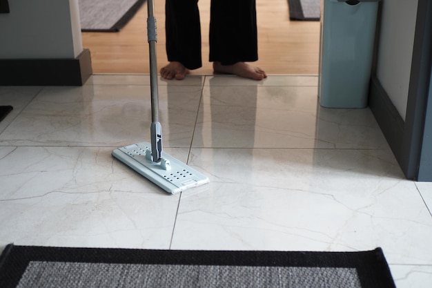 Cleaning tiles floor with mop