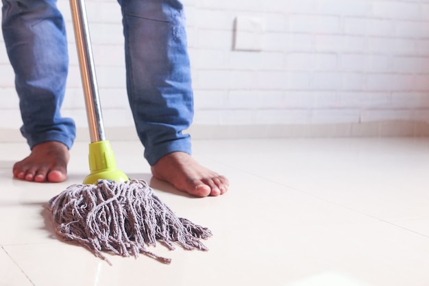 cleaning tiles floor with mop