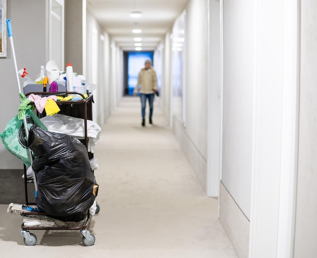 Cleaning utility janitorial cart in hotel corridor