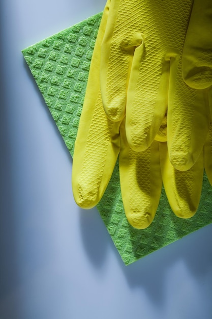 Cleaning washcloth safety gloves on white surface