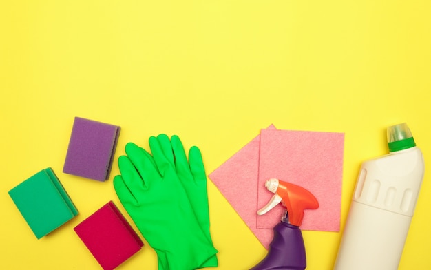 Cleaning and washing products in bottles on a yellow background