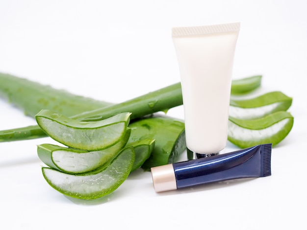 Cleansing foam, cream tube with aloe vera, leaf slices with gel isolated on white background.