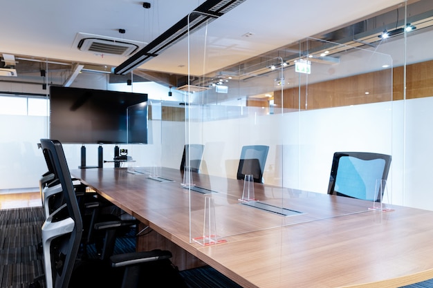 Clear acrylic sheet separates the center on the conference table to prevent Covid19