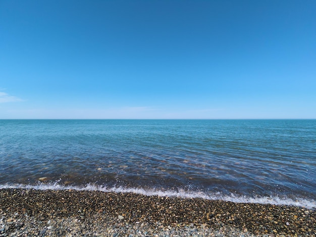 A clear blue sky is visible over the water and the water is clear.