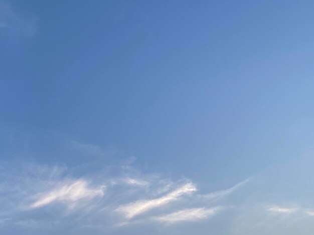 A clear blue sky with a few clouds in it